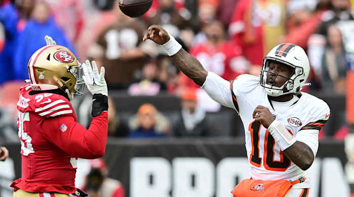 PJ Walker throws a pass for the Browns with a 49ers defender closing in